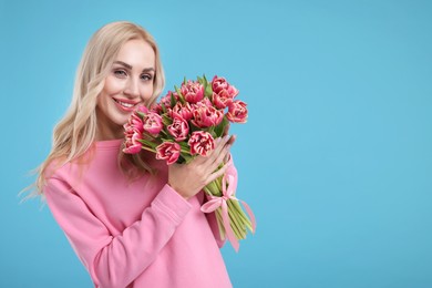 Photo of Beautiful young woman on light blue background