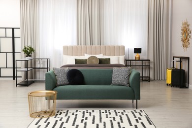 Photo of Beautiful hotel room interior with green sofa