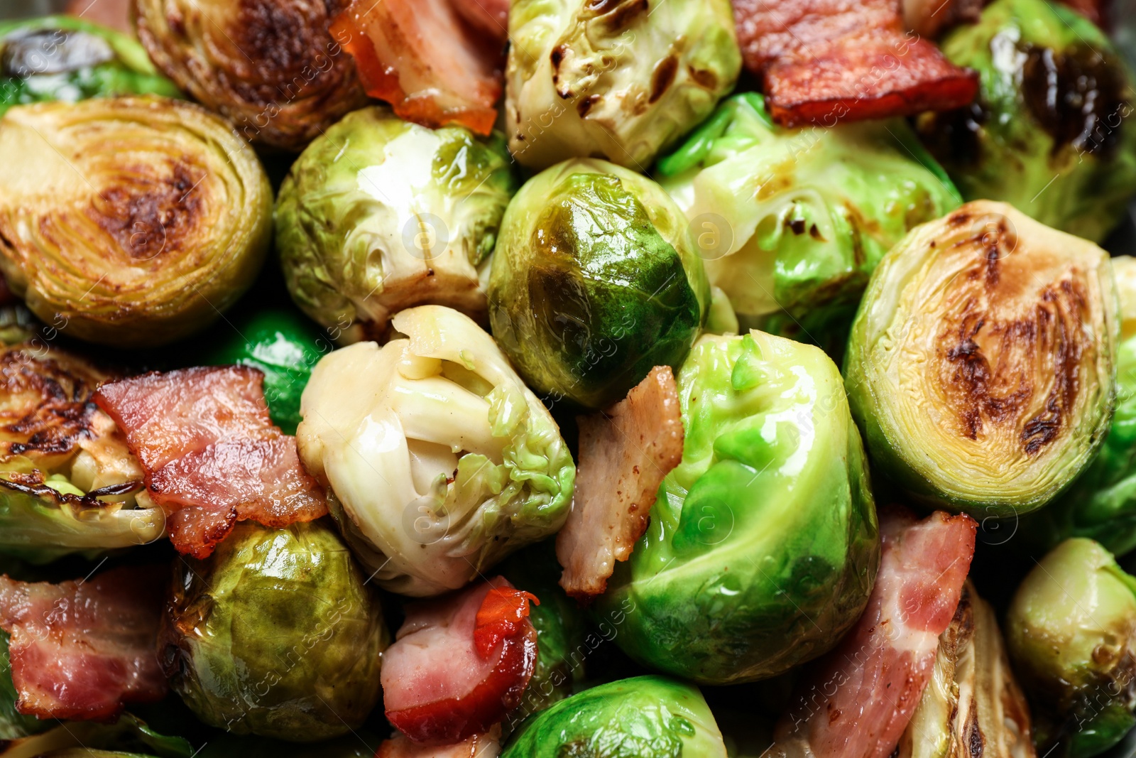 Photo of Closeup view of delicious Brussels sprouts with bacon