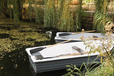 Modern boats with wooden oars on lake