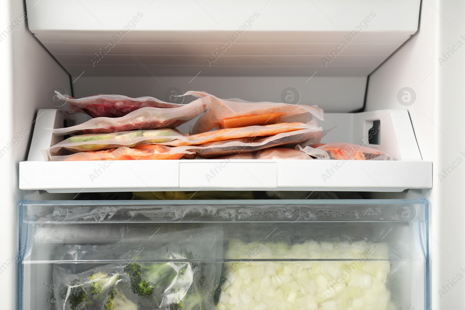 Photo of Vacuum bags with different products in fridge. Food storage