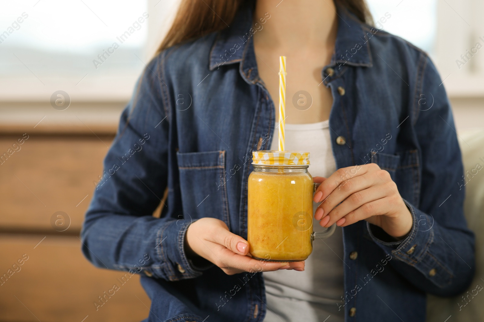 Photo of Woman with delicious smoothie indoors, closeup view