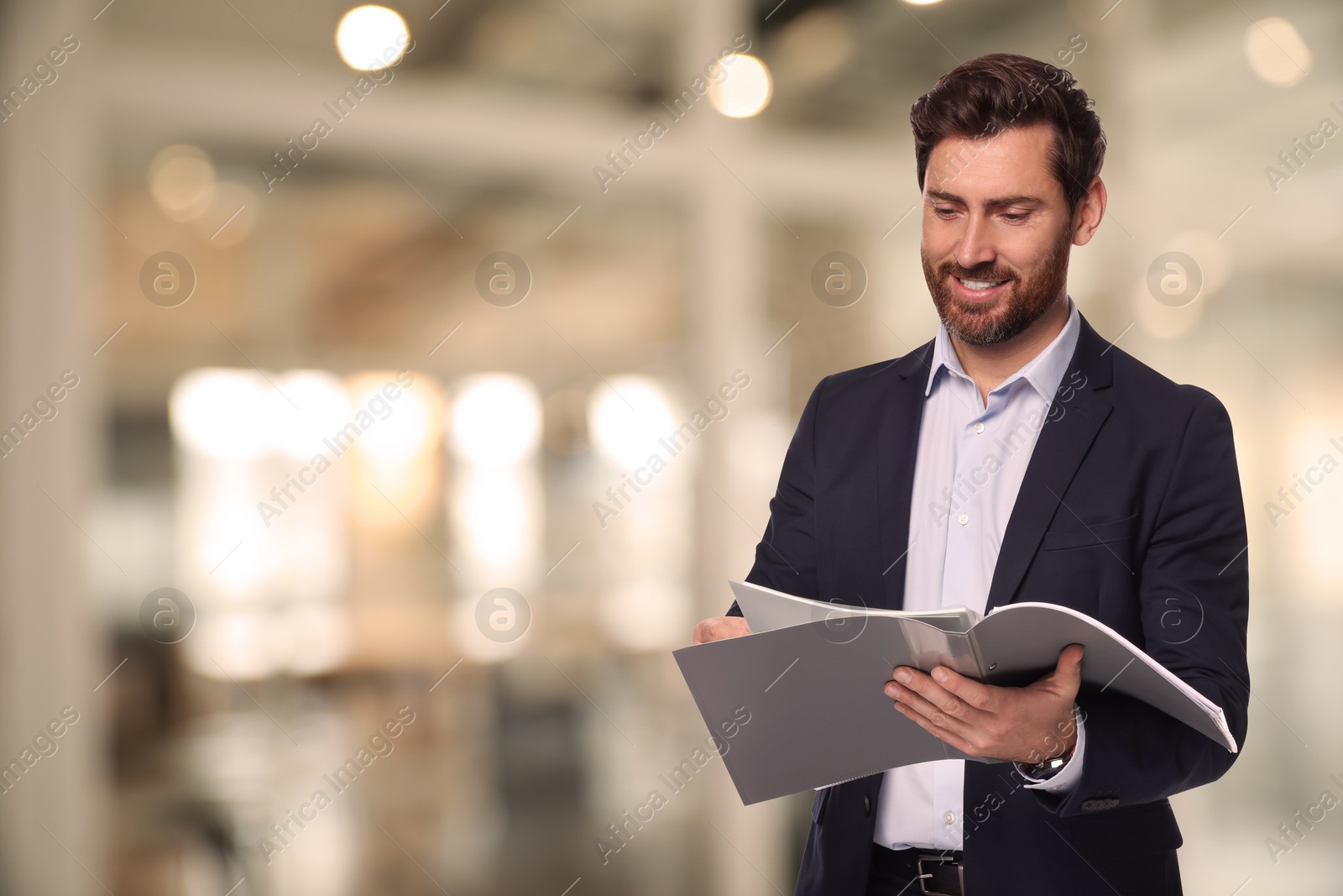 Image of Successful lawyer reading documents on blurred background, space for text