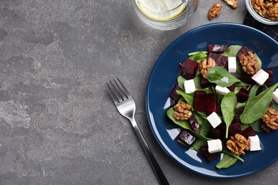 Fresh delicious beet salad on grey table, flat lay. Space for text