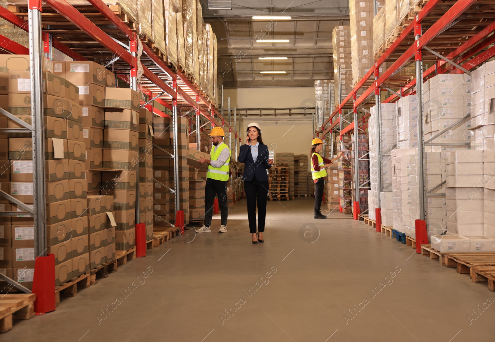 Image of Manager and worker at warehouse. Logistics center