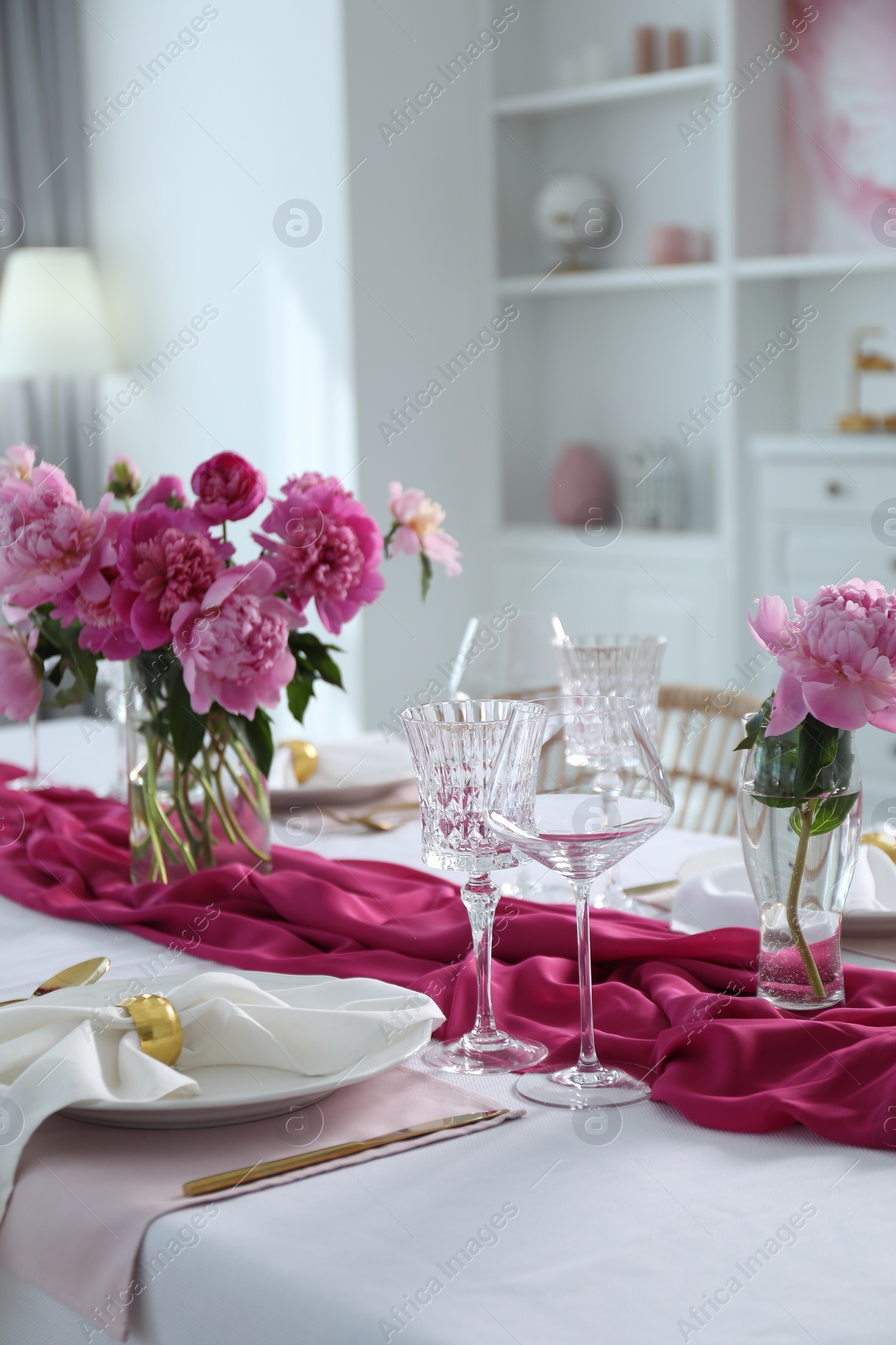 Photo of Beautiful table setting with pink peonies in dining room