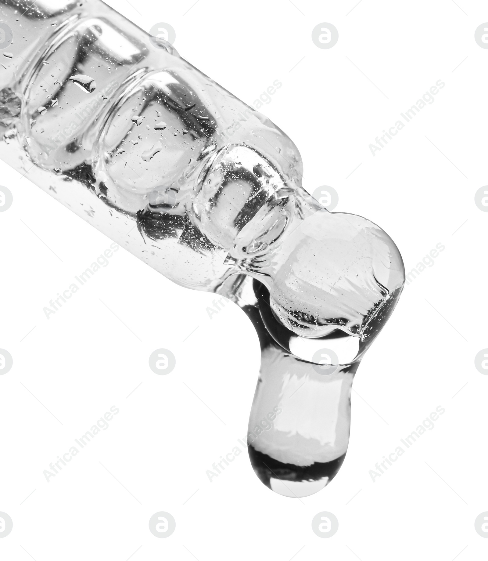 Photo of Dripping face serum from pipette on white background, closeup. Space for text