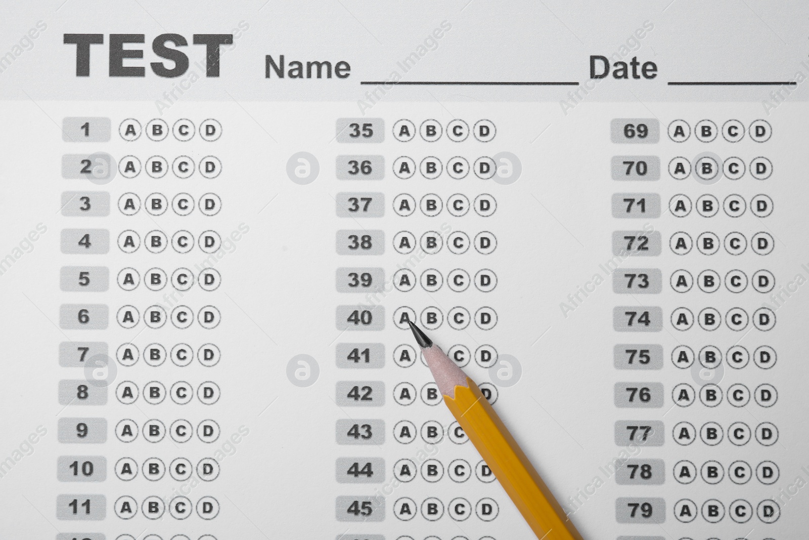 Photo of Pencil on answer sheet, top view. Student passing exam