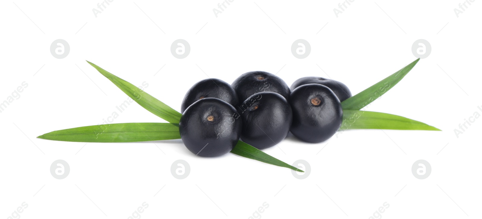 Photo of Pile of fresh ripe acai berries and green leaves on white background