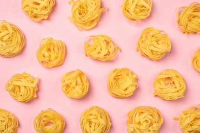 Flat lay composition with raw pasta on color background