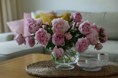 Photo of Beautiful pink peonies in vase on table at home. Interior design