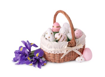 Photo of Wicker basket with beautifully painted Easter eggs and iris flowers isolated on white