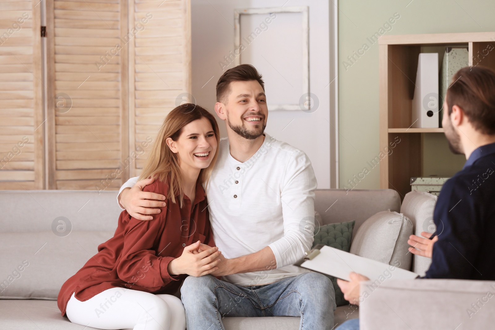 Photo of Family psychologist working with young couple in office