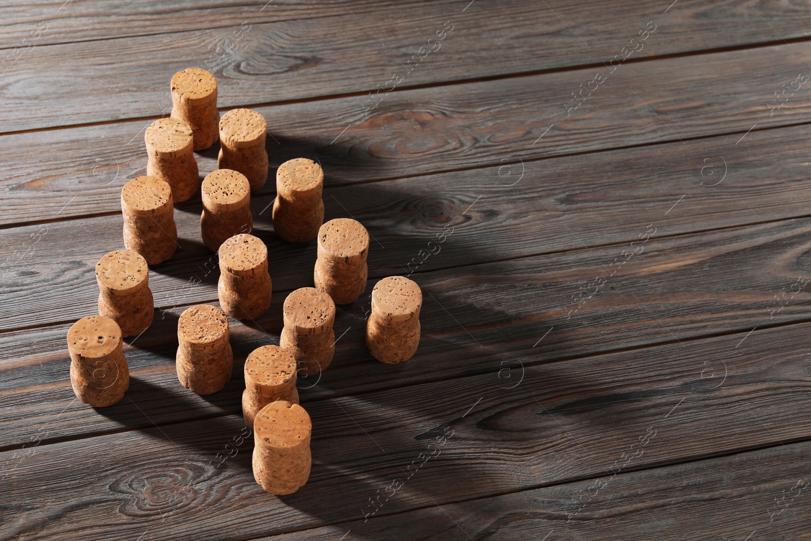 Photo of Christmas tree made of wine corks on wooden table. Space for text