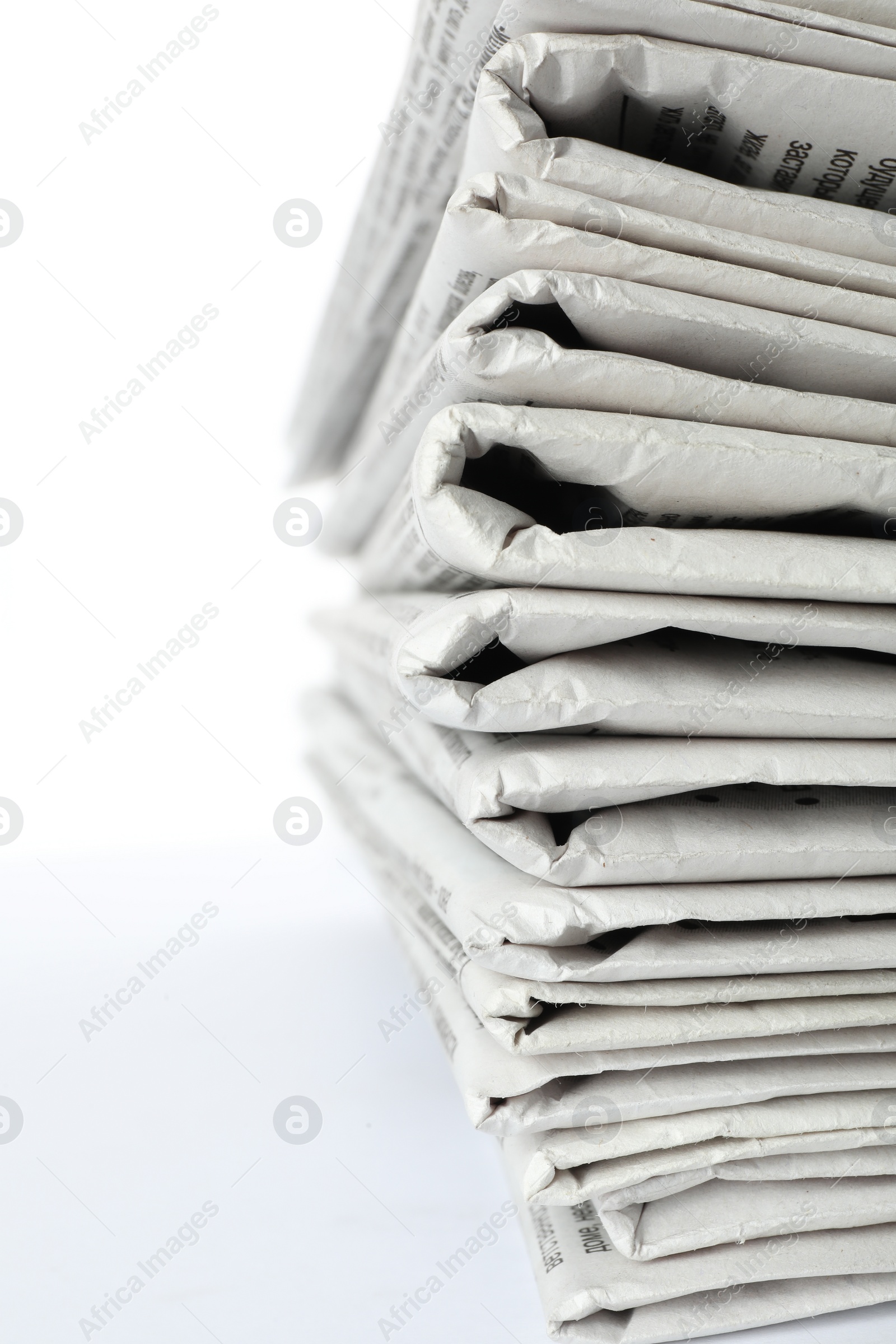 Photo of Stack of newspapers on white background, closeup. Journalist's work