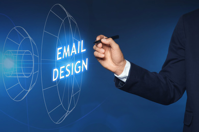 Image of Businessman pointing at phrase EMAIL DESIGN on virtual screen, closeup