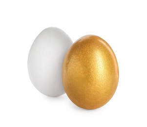 Photo of Golden egg and ordinary one on white background
