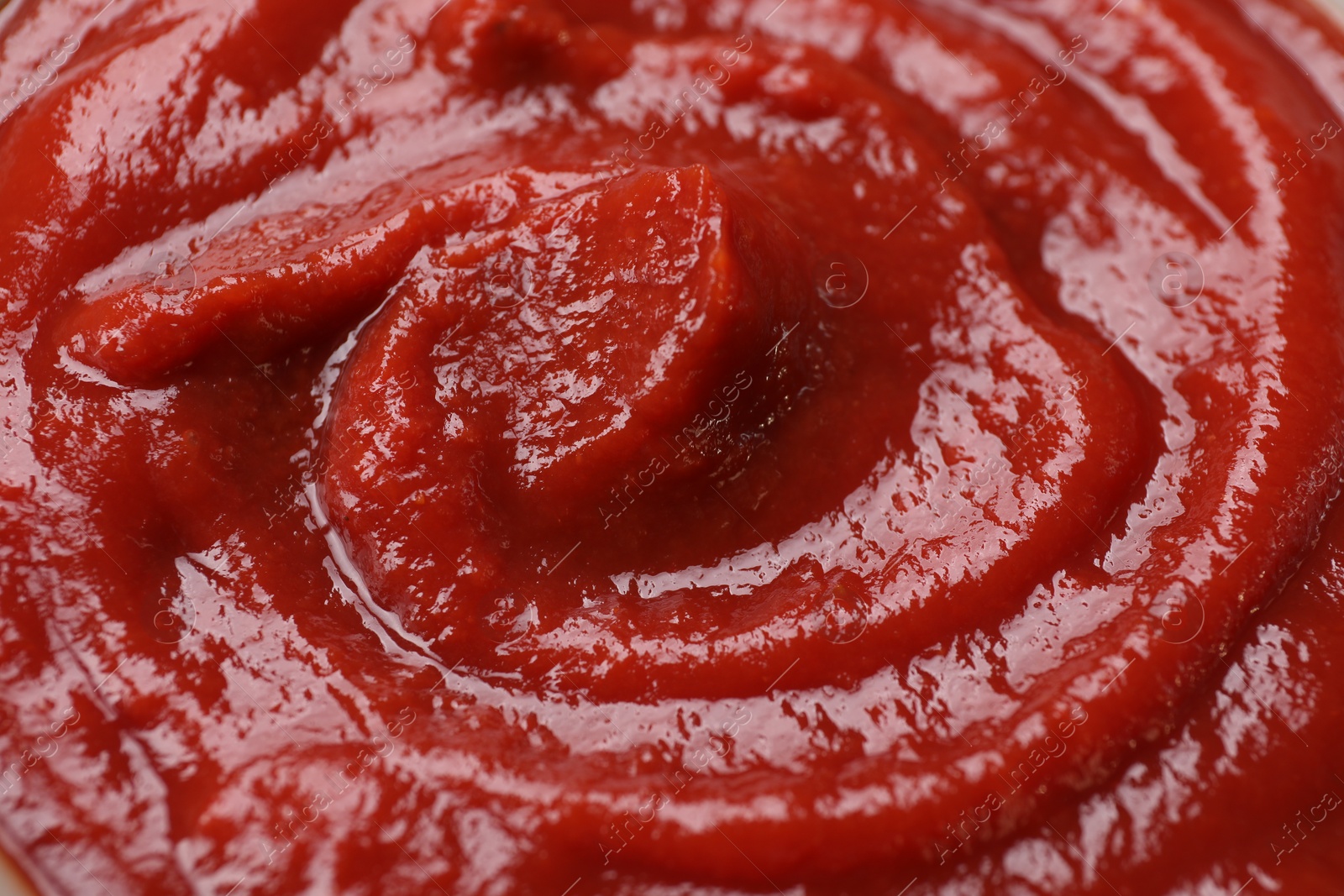 Photo of Organic ketchup as background, closeup. Tomato sauce