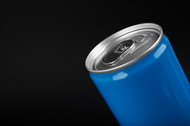 Light blue can of energy drink on black background, closeup. Space for text