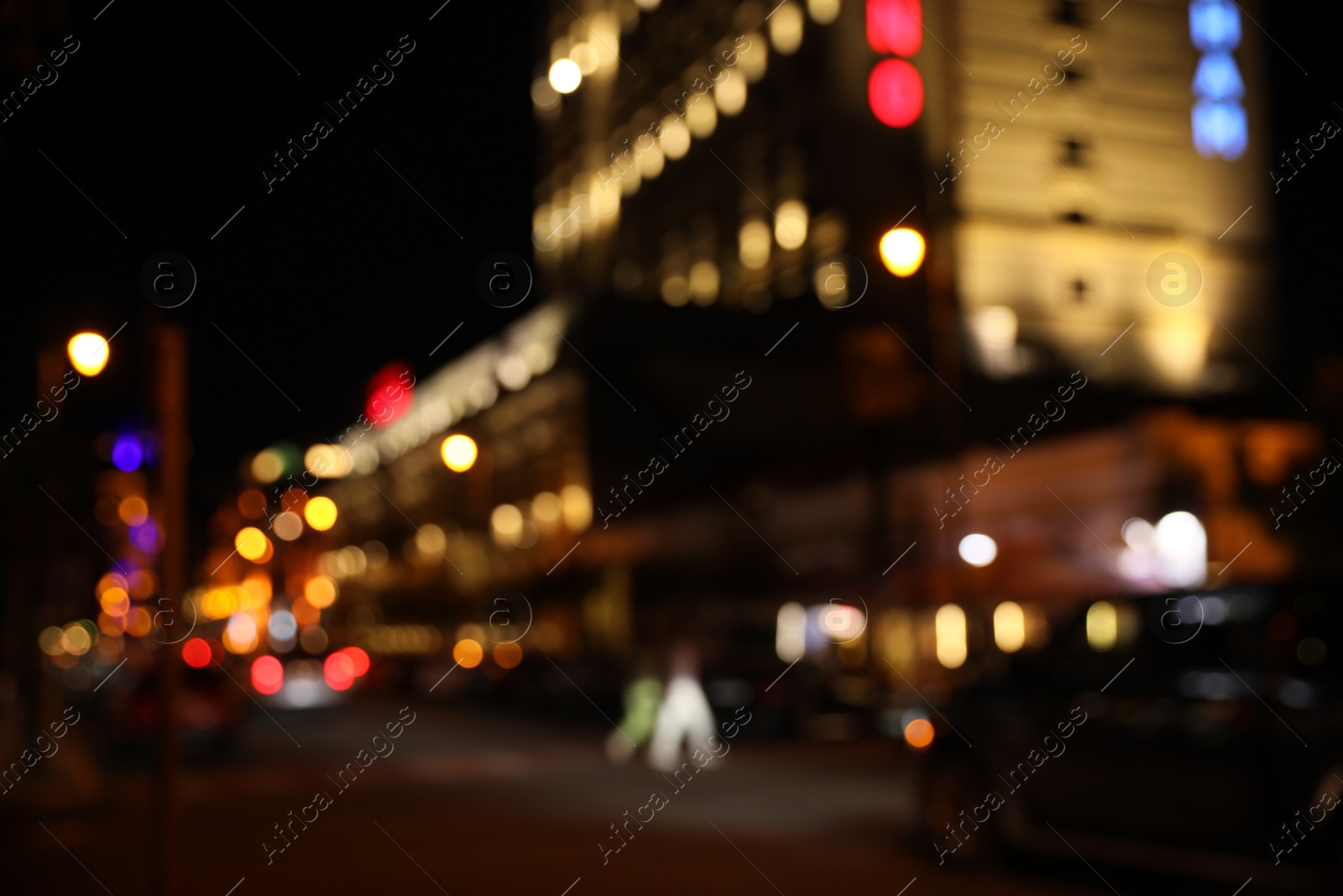 Photo of Blurred view of city street with lights at night. Bokeh effect