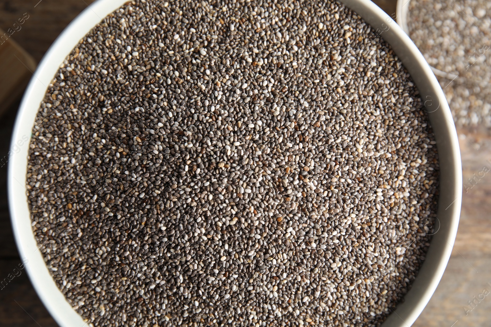 Photo of Bowl with chia seeds on table, top view