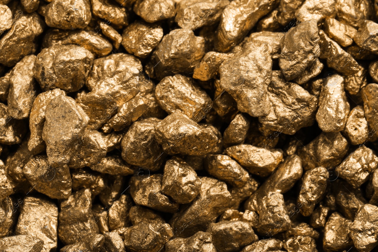 Photo of Pile of gold nuggets as background, closeup