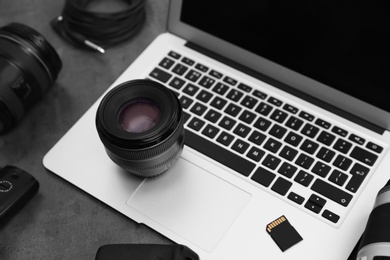 Photo of Professional photographer equipment and laptop on table