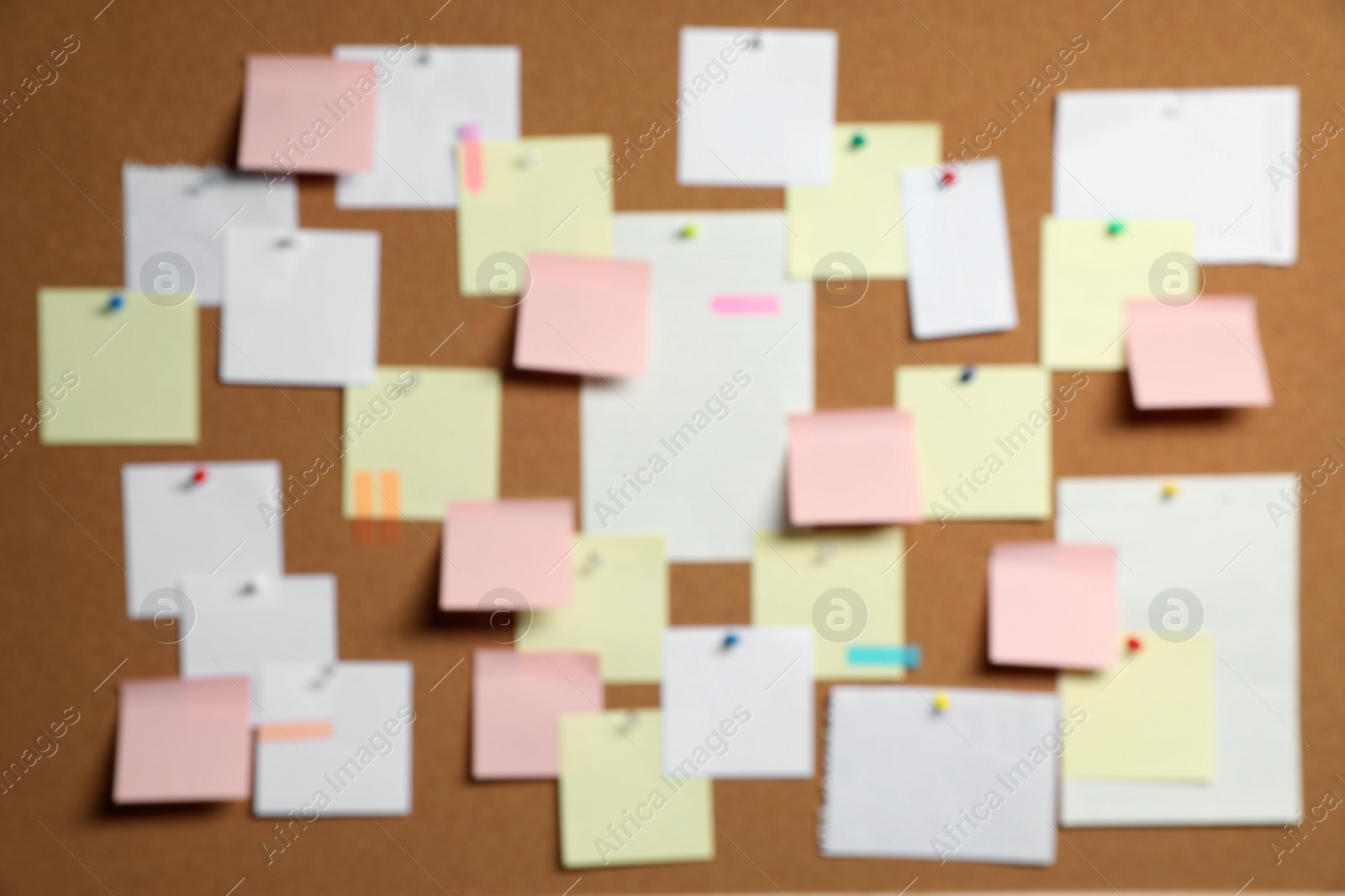 Photo of Blurred view of cork board with many colorful notes