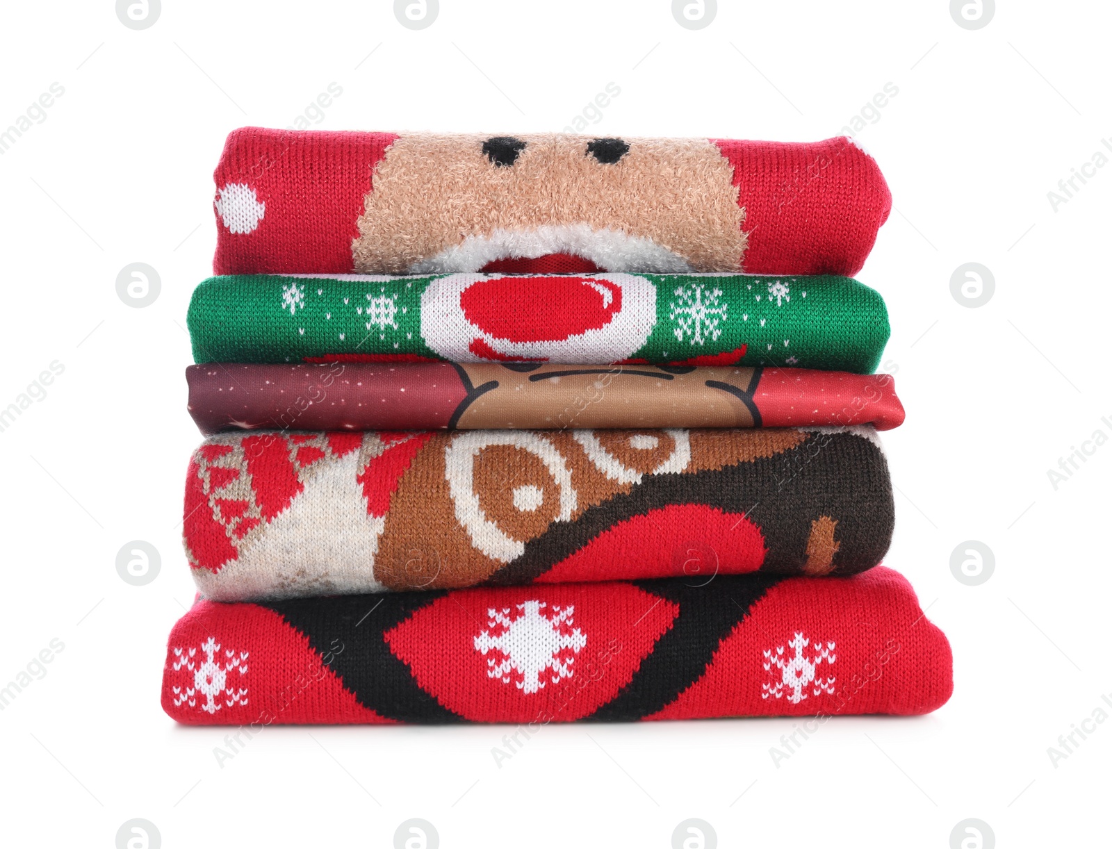 Photo of Stack of warm Christmas sweaters isolated on white