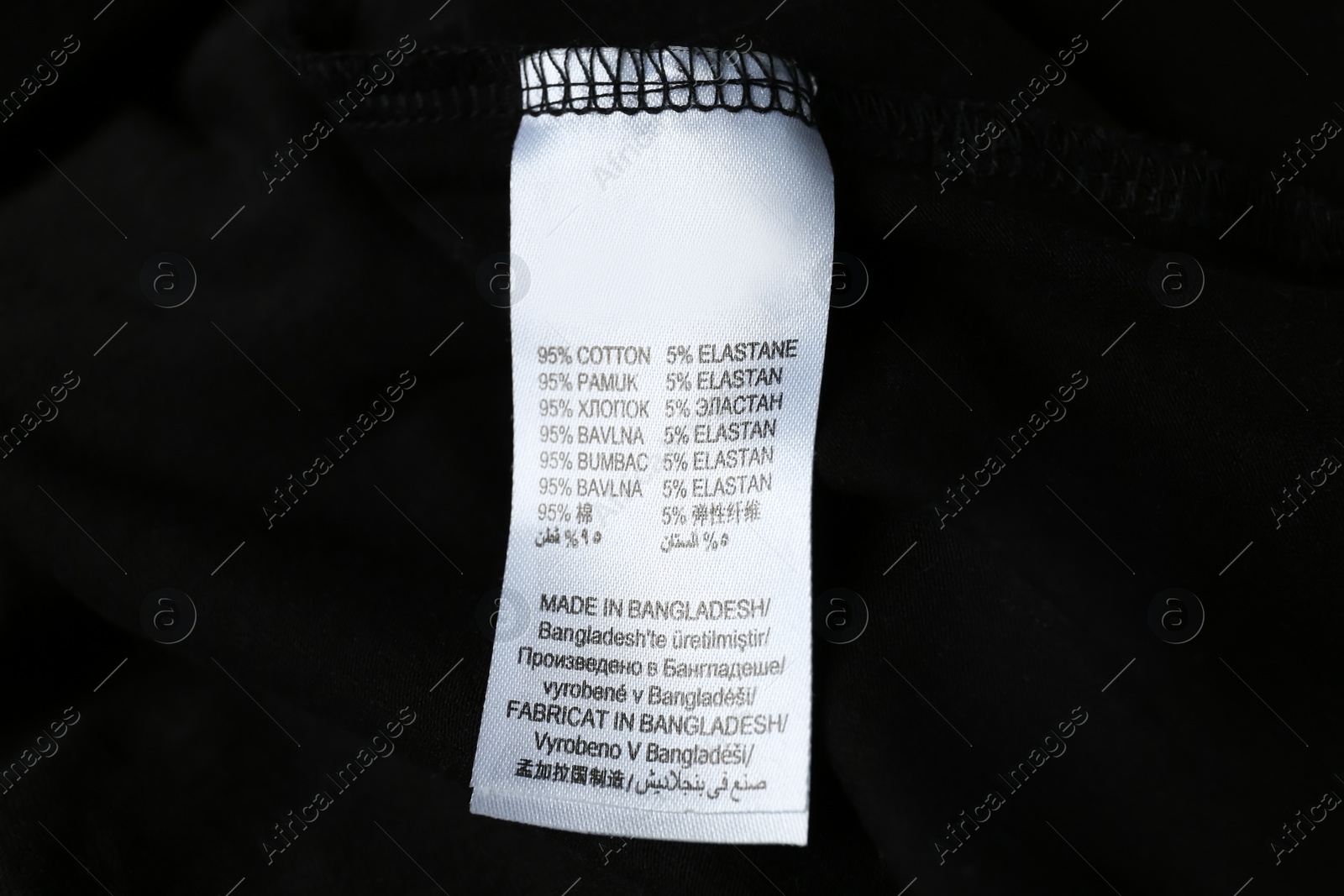 Photo of Clothing label with material content on black shirt, closeup view