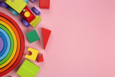 Different children's toys on pink background, flat lay. Space for text