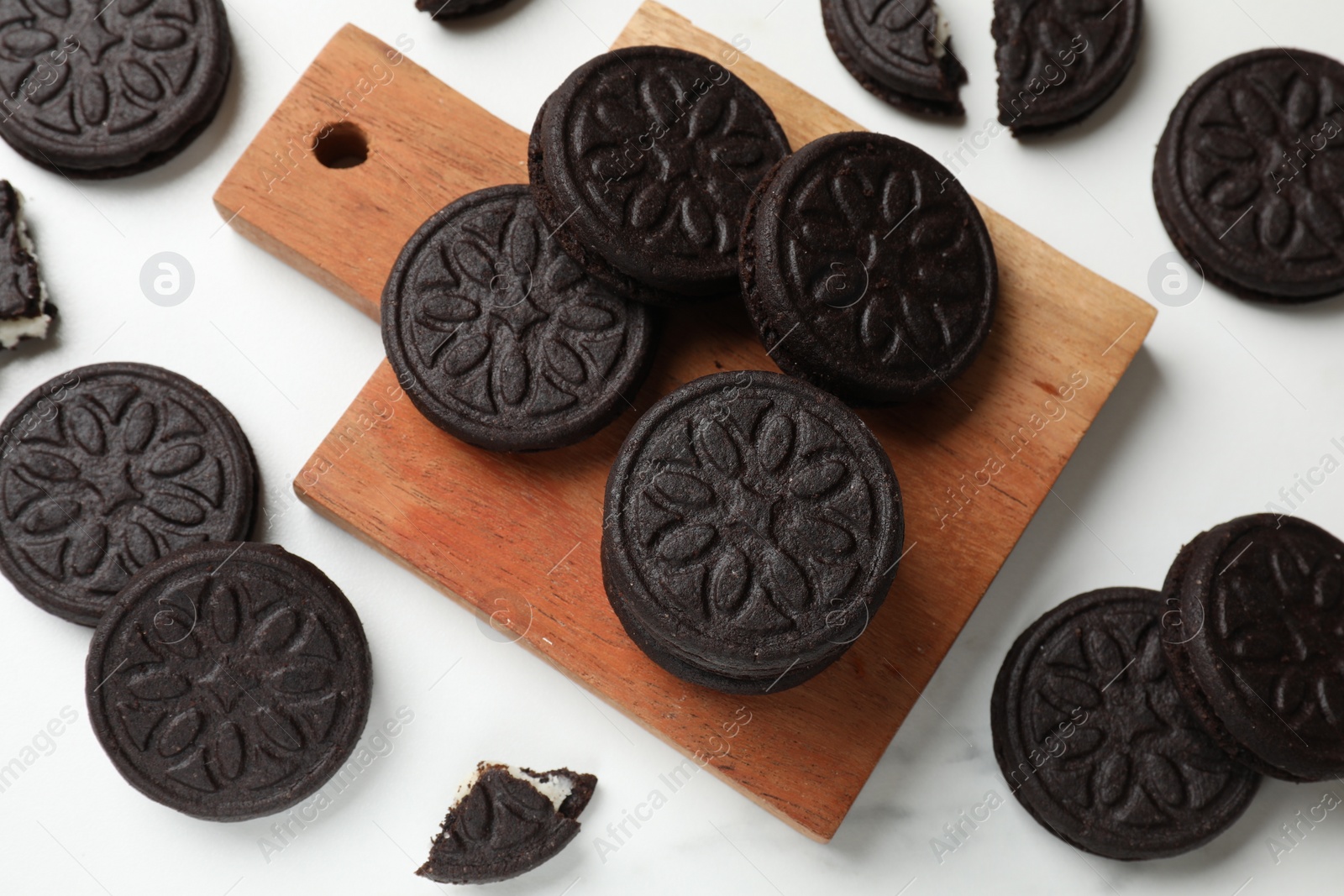 Photo of Tasty sandwich cookies on white table, flat lay