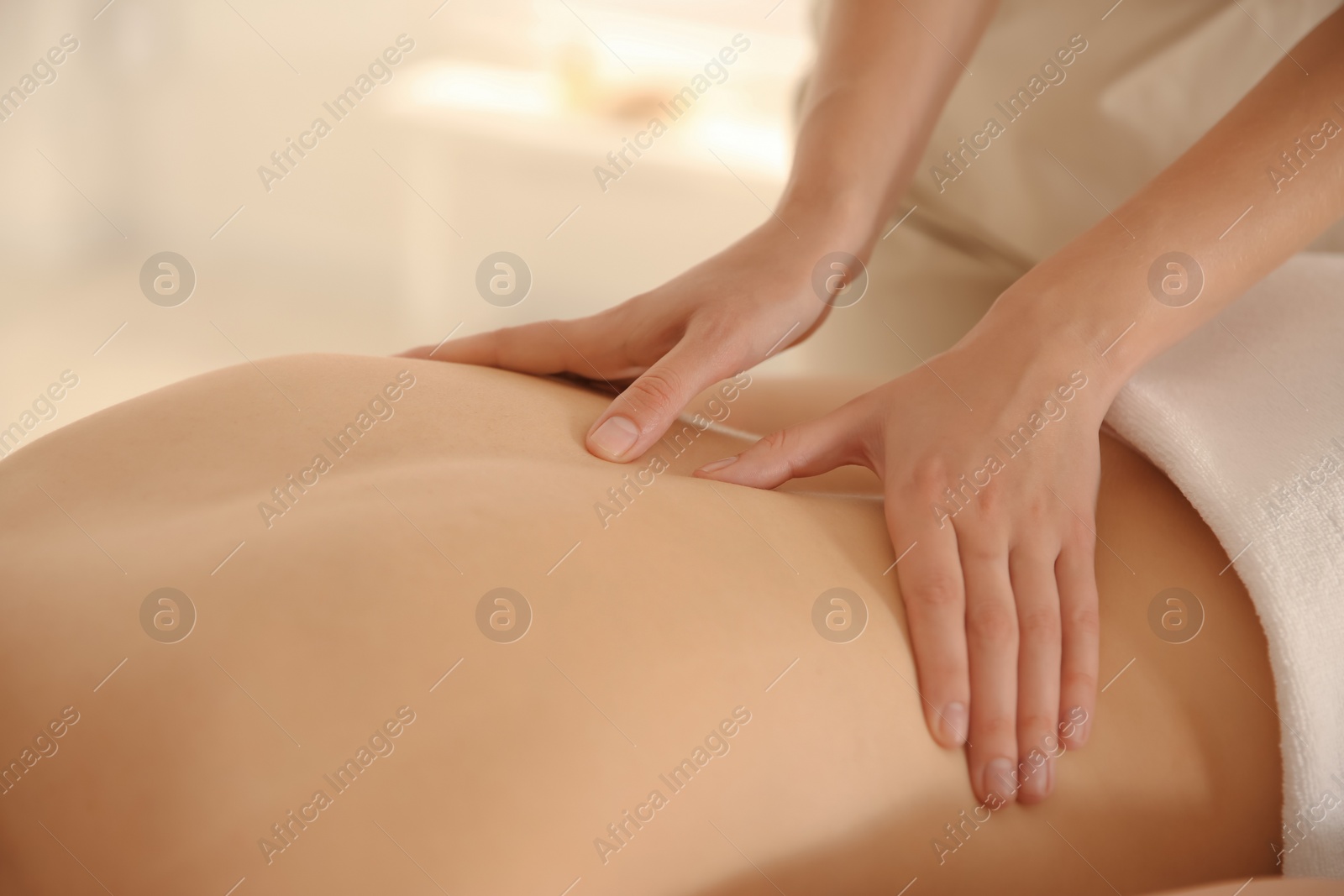 Photo of Young woman receiving back massage in spa salon, closeup