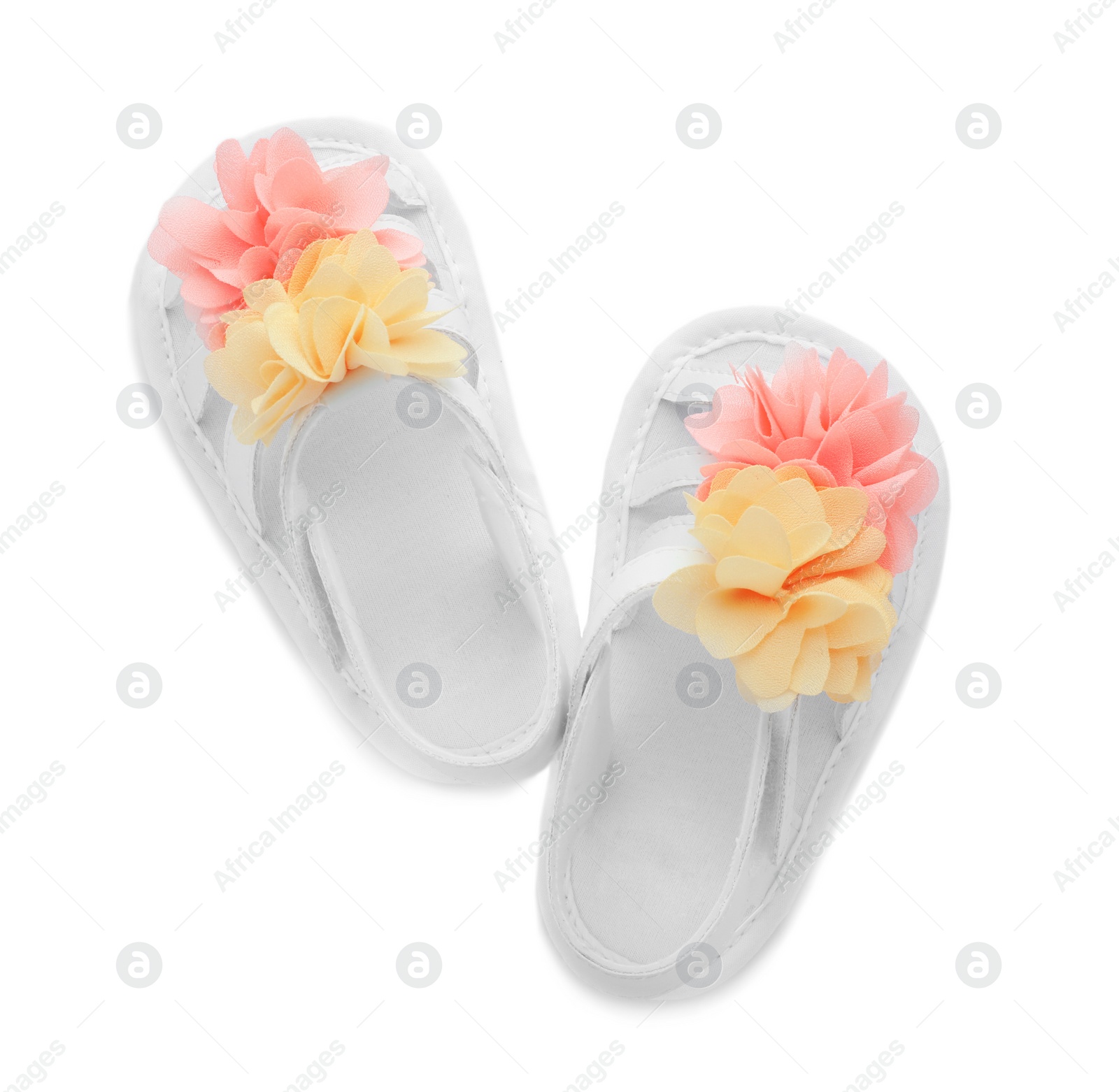 Photo of Pair of baby sandals decorated with flowers on white background, top view