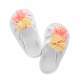 Pair of baby sandals decorated with flowers on white background, top view