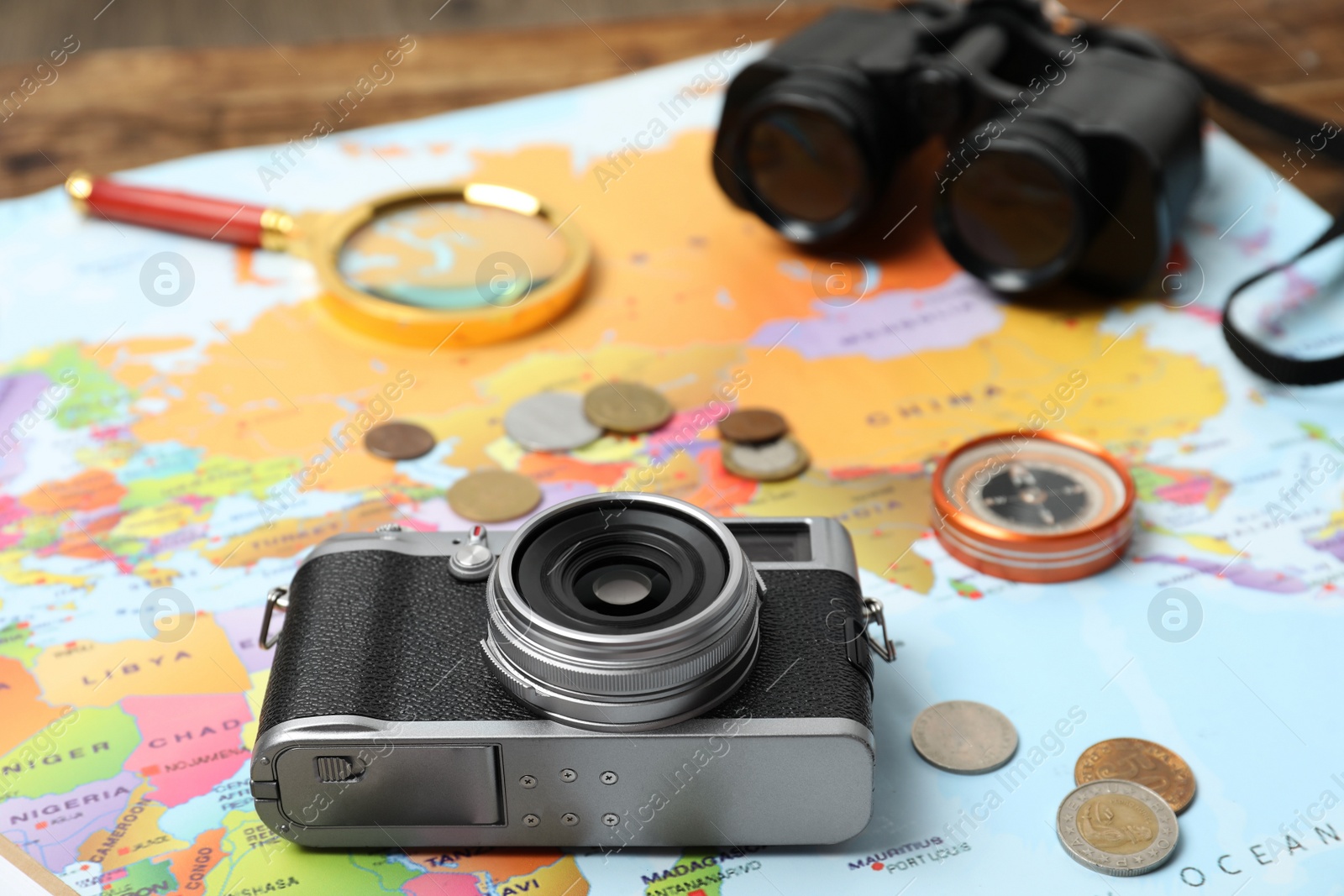 Photo of Different travel accessories on world map. Planning summer vacation trip