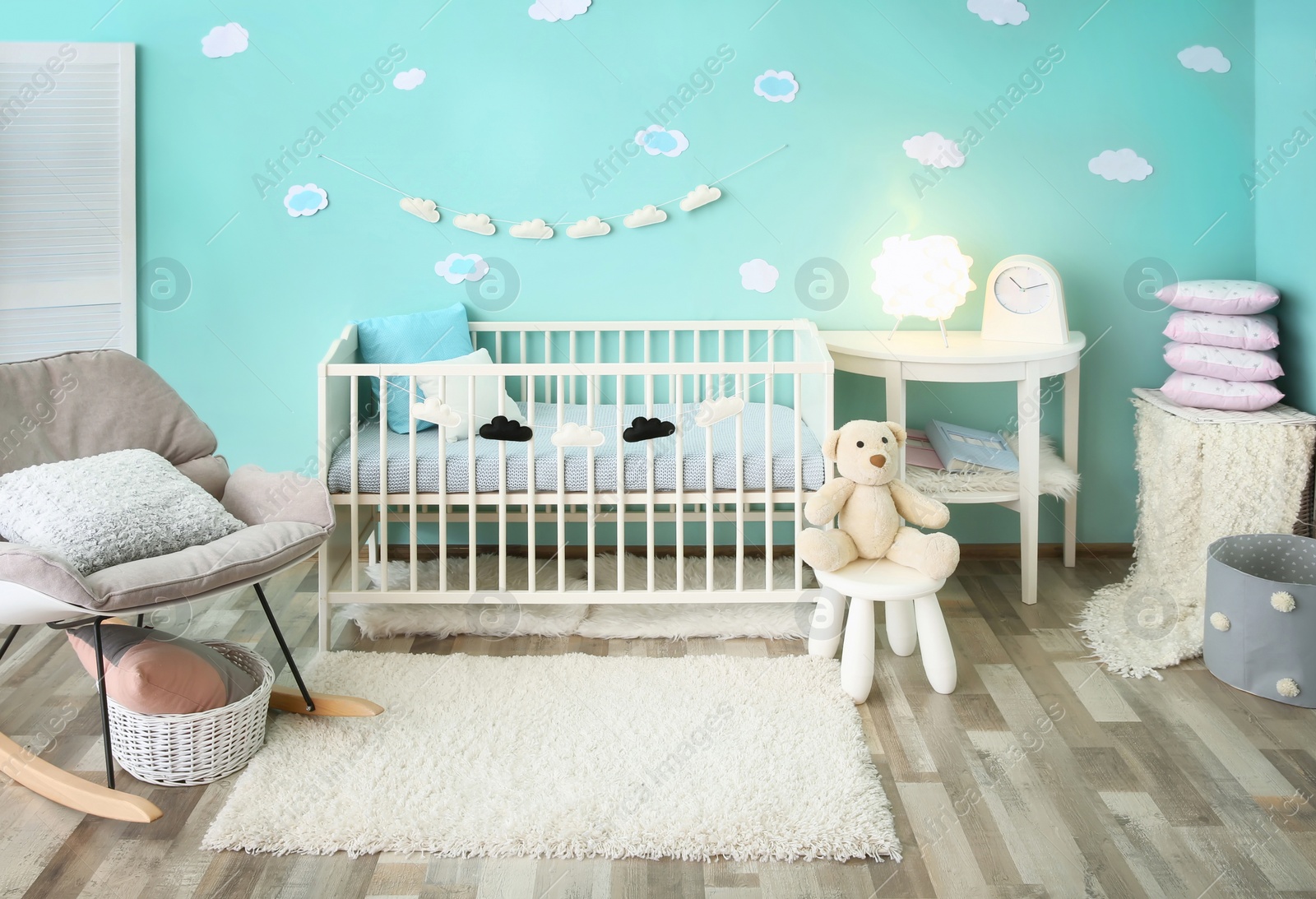 Photo of Modern baby room interior with crib and rocking chair