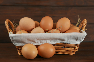 Raw brown chicken eggs on wooden table