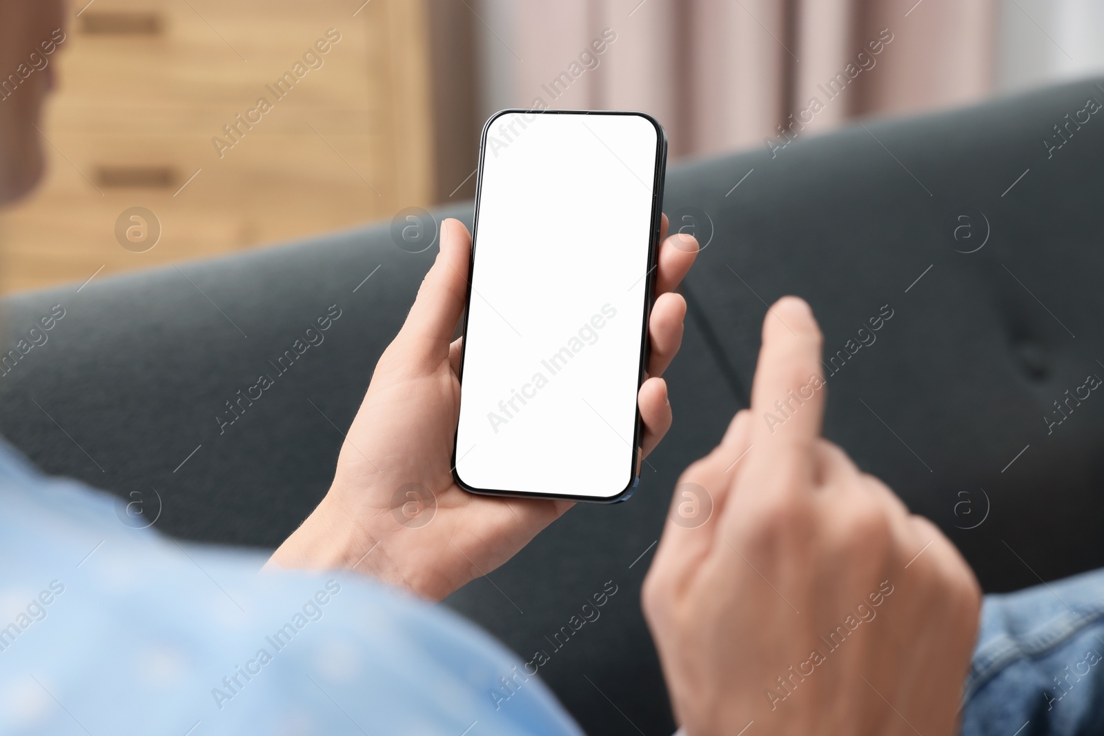 Photo of Woman using smartphone at home, closeup. Space for text