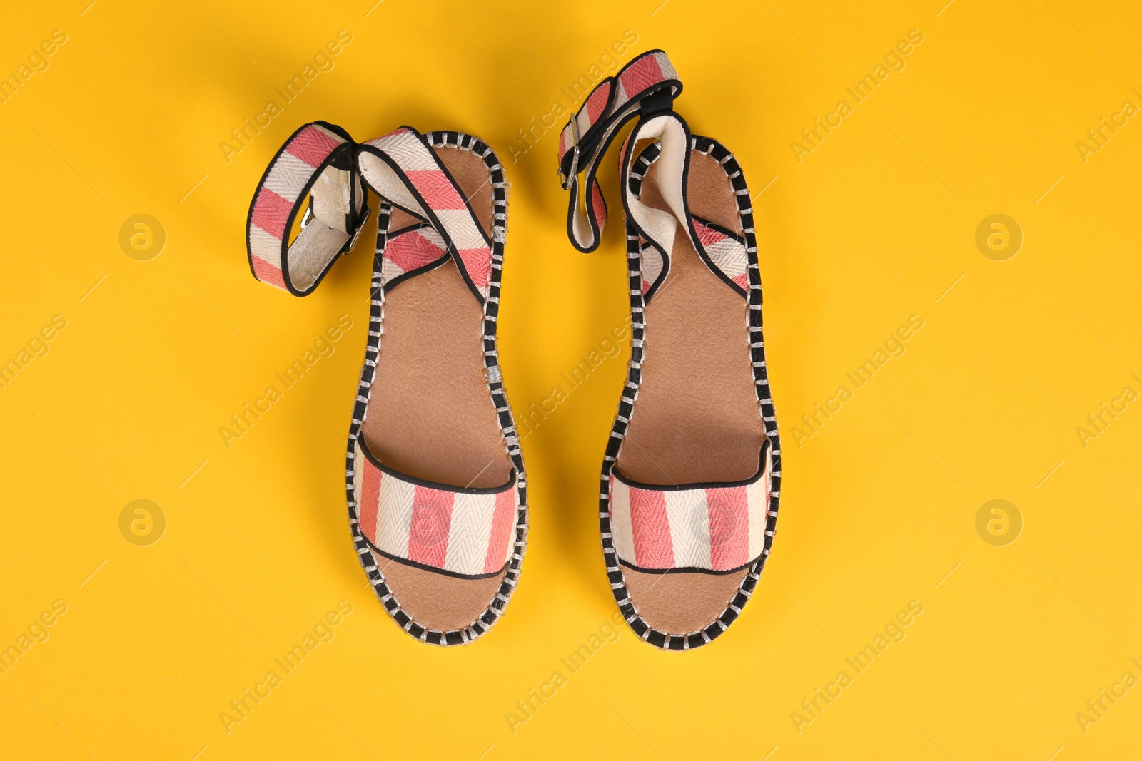 Photo of Pair of female shoes on color background, top view