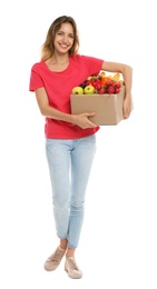 Photo of Young woman with box of fresh vegetables on white background