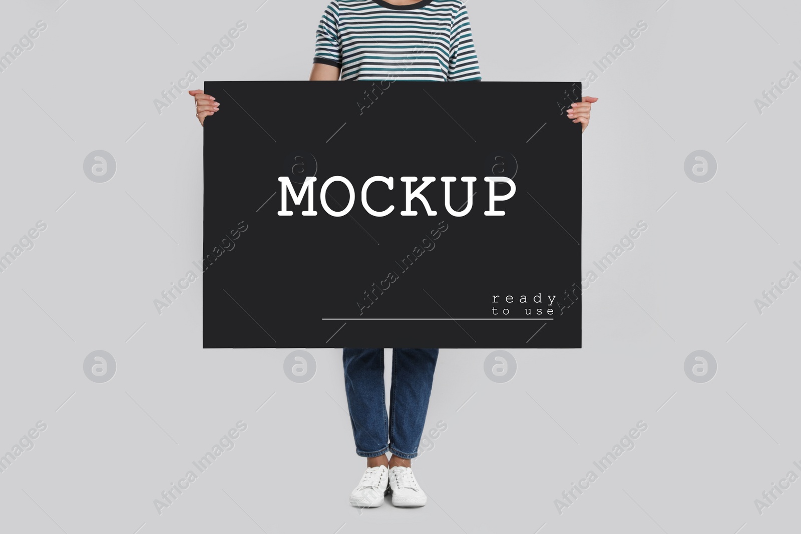 Image of Woman holding black poster with text Mockup Ready To Use on light background, closeup