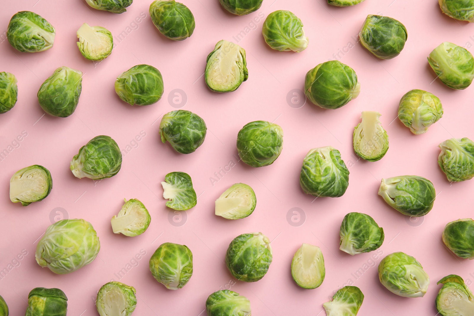 Photo of Fresh Brussels sprouts on pink background, flat lay