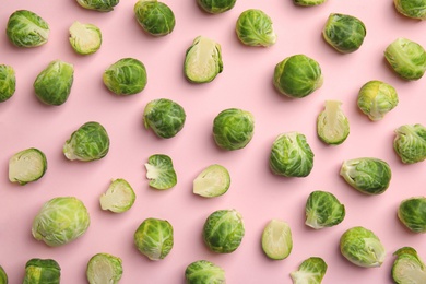 Fresh Brussels sprouts on pink background, flat lay