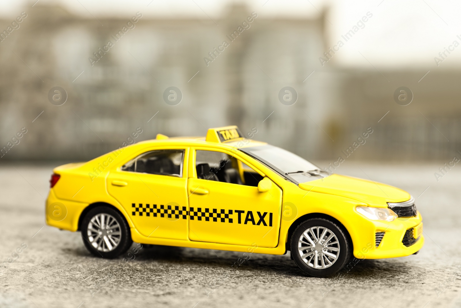 Photo of Yellow taxi car model on city street
