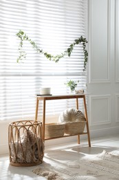 Stylish room decorated with beautiful eucalyptus garland