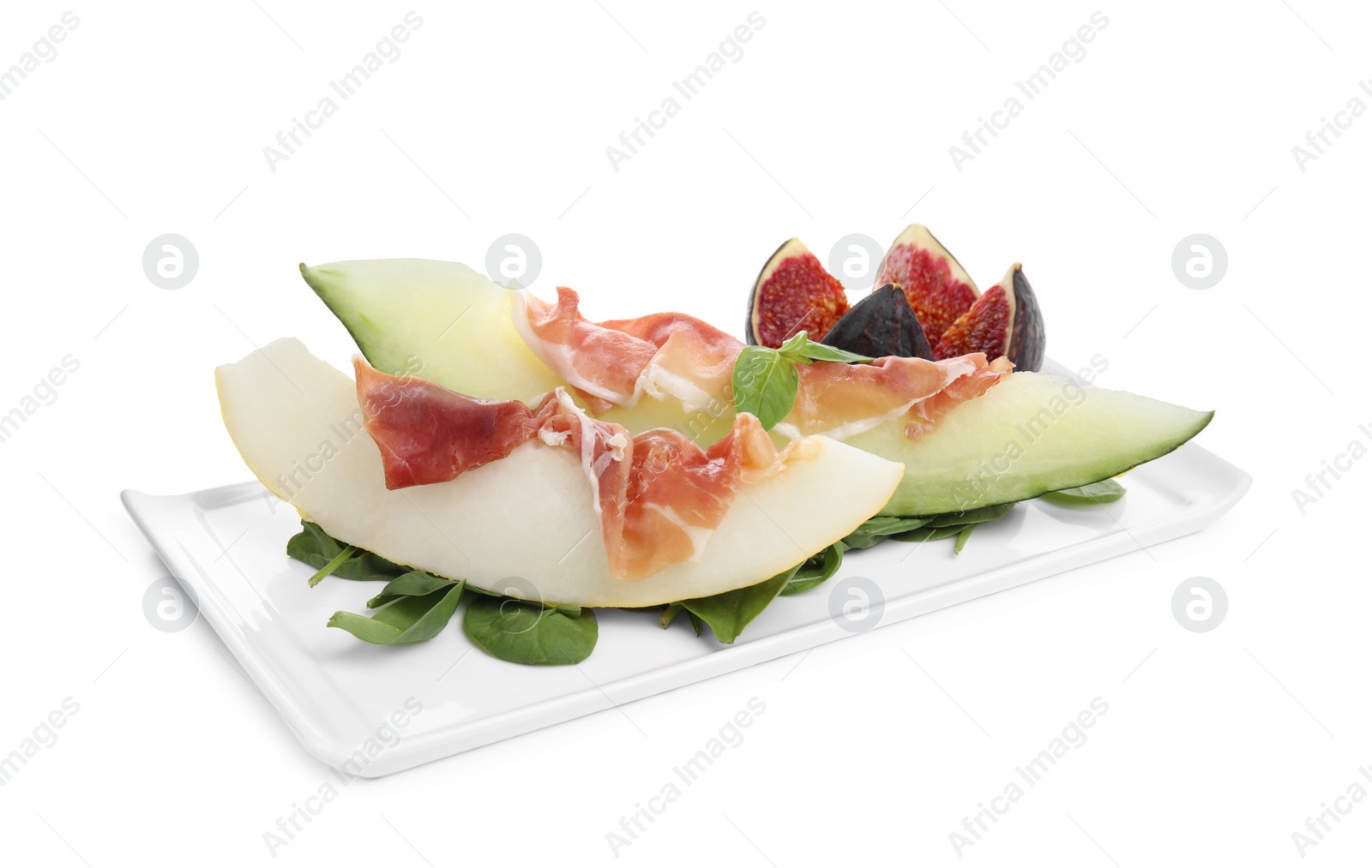 Photo of Plate with tasty melon, jamon, figs and spinach isolated on white
