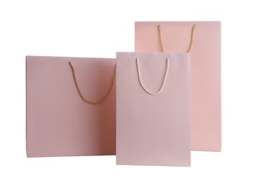 Photo of Pink paper shopping bags isolated on white