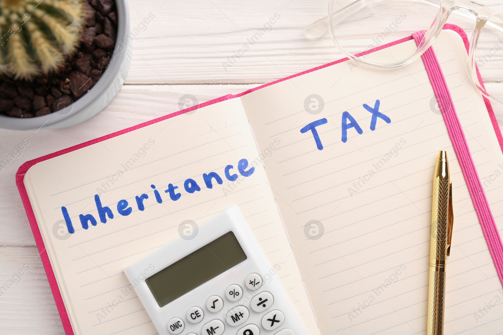 Photo of Notepad with phrase Inheritance Tax, glasses and calculator on white wooden table, flat lay