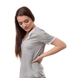 Young woman suffering from back pain on white background